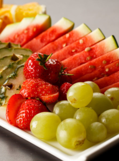 Plate of fresh fruit with grapes, watermelon and pineapple